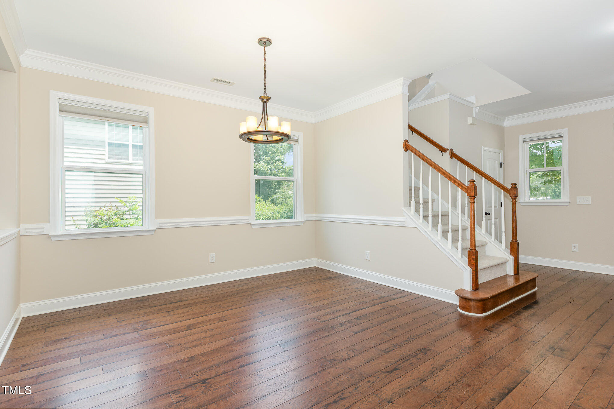1304 Barnford Mill Road Wake Forest, NC 27587 - Photo 5 of 40 a view of an empty room with wooden floor windows and a chandelier