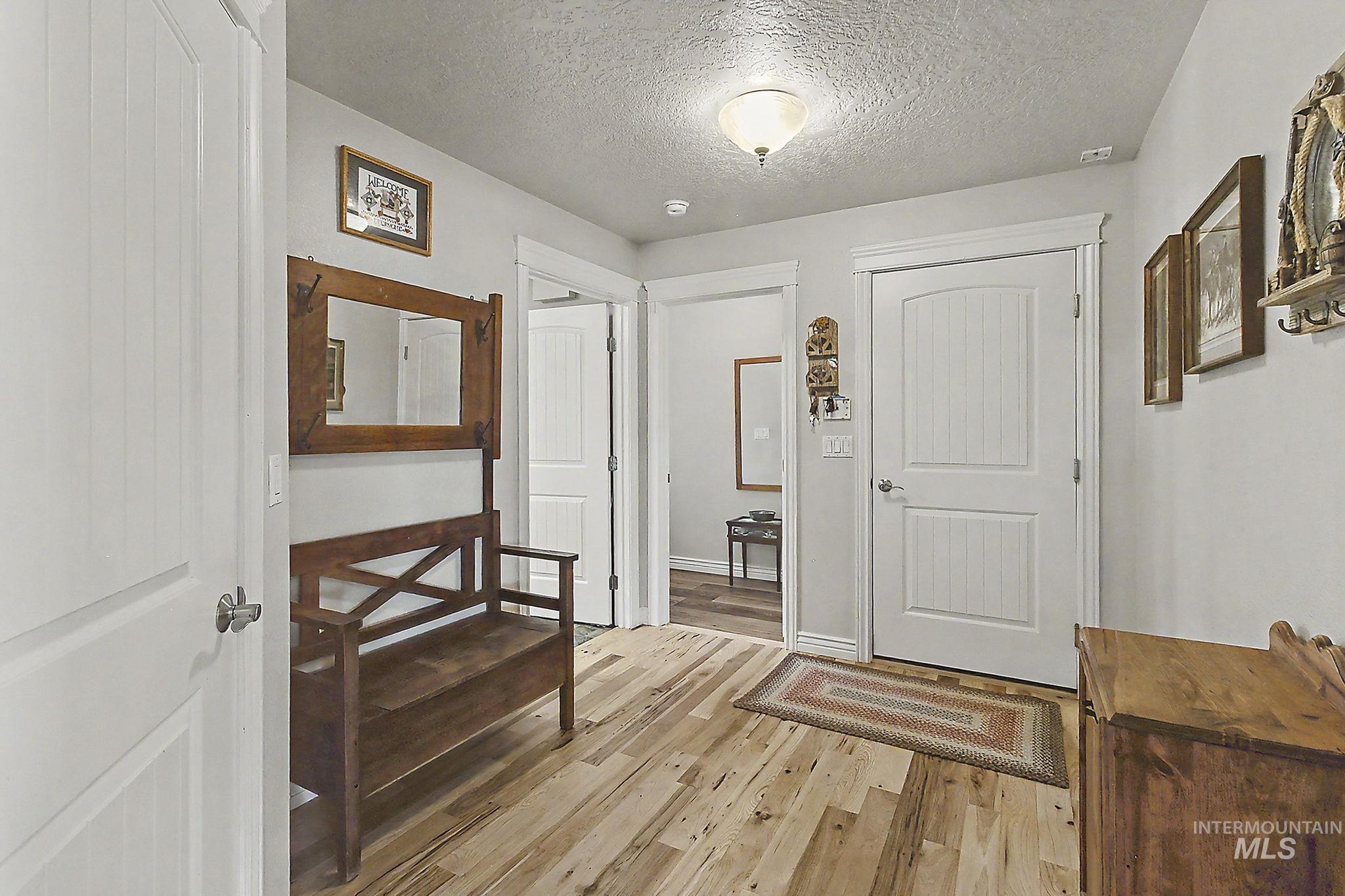 6900 West Charters Lane Melba, ID 83641 - Photo 19 of 49 Wood-finish flooring with a flush-mounted ceiling light fixture