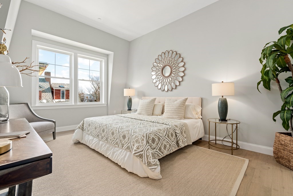 54 Pleasant Street, Unit 5 Boston, MA 02125 - Photo 6 of 23 a bedroom with bed and a potted plant on the dresser