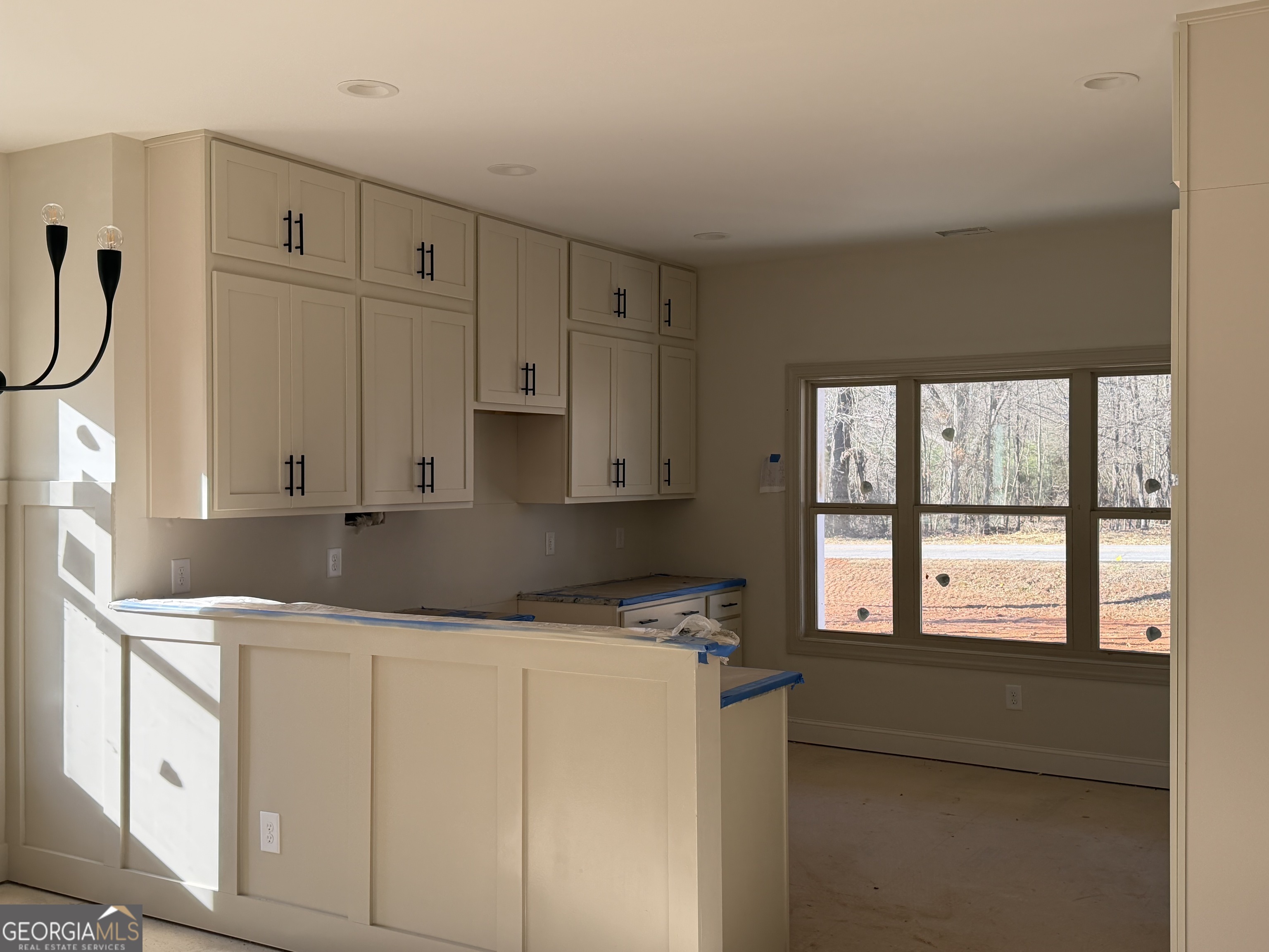 981 Horsley Mill Road Carrollton, GA 30116 - Photo 5 of 9 a kitchen with granite countertop white cabinets and white appliances