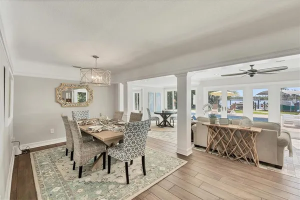 a view of a dining room with furniture wooden floor and chandelier