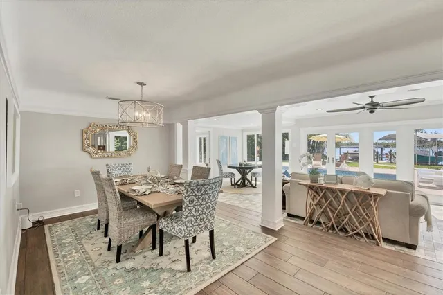 a view of a dining room with furniture wooden floor and chandelier