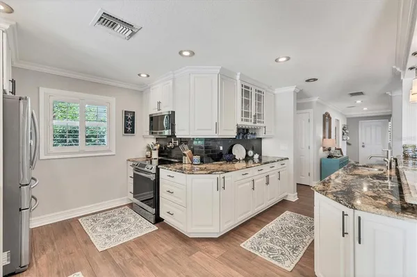 a spacious bathroom with a granite countertop sink a mirror and shower