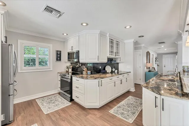a spacious bathroom with a granite countertop sink a mirror and shower