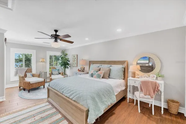 a bedroom with a bed and a chandelier
