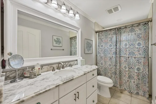 a bedroom with a bed and large window