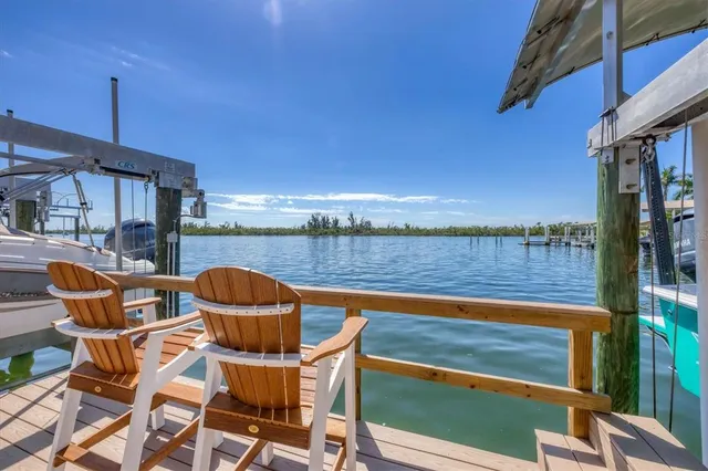 a view of a patio with table and chairs under an umbrella