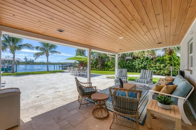 a backyard of a house with barbeque oven table and chairs
