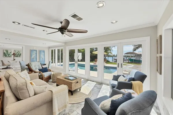 a living room with furniture and a ceiling fan