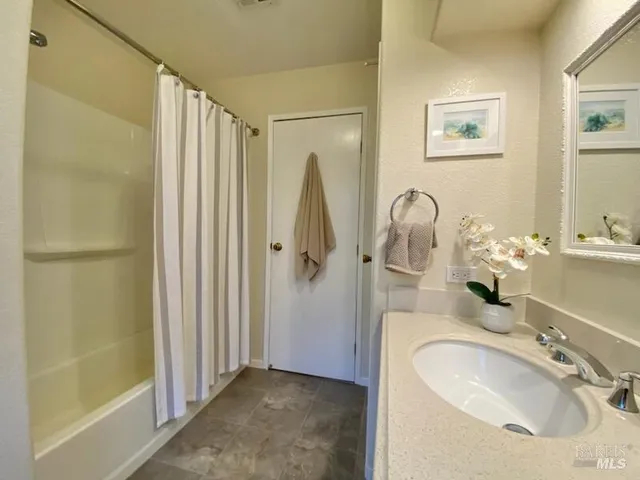 a bathroom with a sink tub and shower