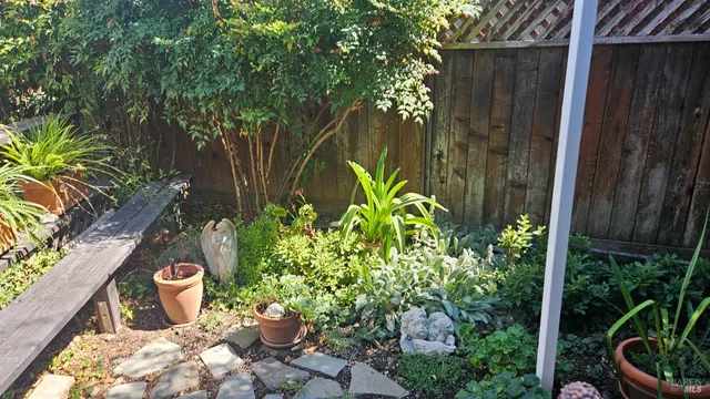 a wooden fence with some potted plants