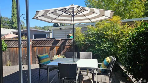 a view of backyard of house with seating space