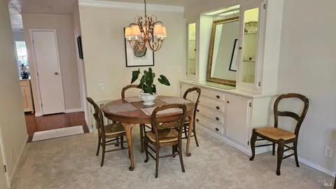 a view of a dining room with furniture and chandelier