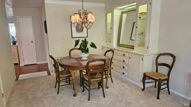 a view of a dining room with furniture and chandelier