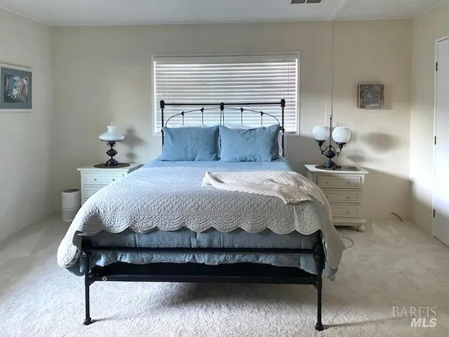 a bedroom with a bed and window
