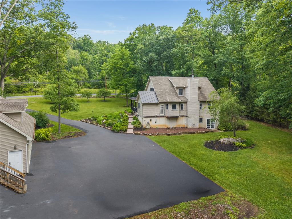 465 Raubsville Road Easton, PA 18042 - Photo 7 of 60 A spacious driveway leads to a private residence nestled amidst verdant mature trees and landscaped grounds.