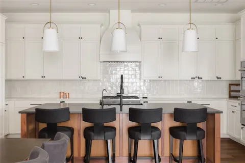 a kitchen with kitchen island a large counter top space a sink appliances and living room view