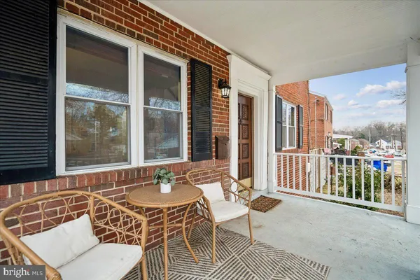 a balcony with table and chairs