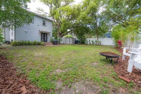 a view of a house with a yard and sitting area