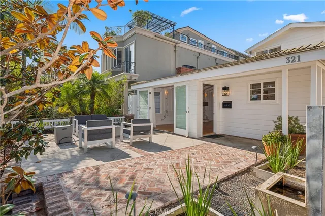 a view of a patio with table and chairs with wooden fence and plants