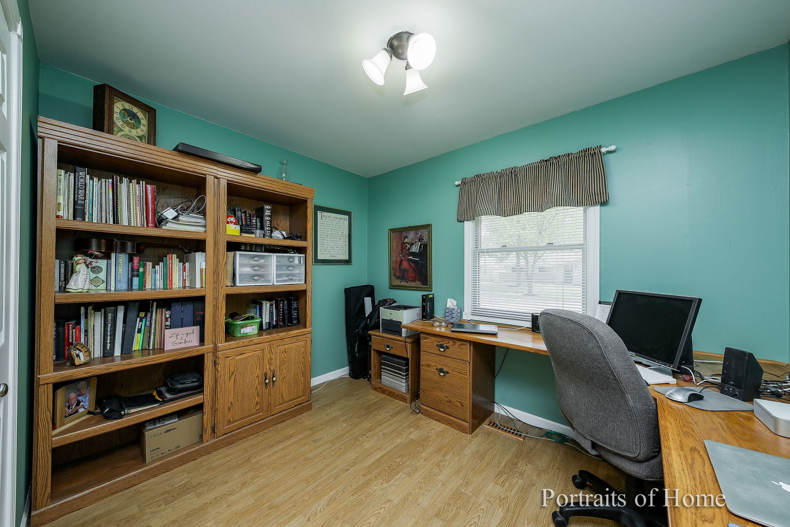 310 Audubon Road Streamwood, IL 60107 - Photo 8 of 10 a view of a workspace with furniture and a bookshelf
