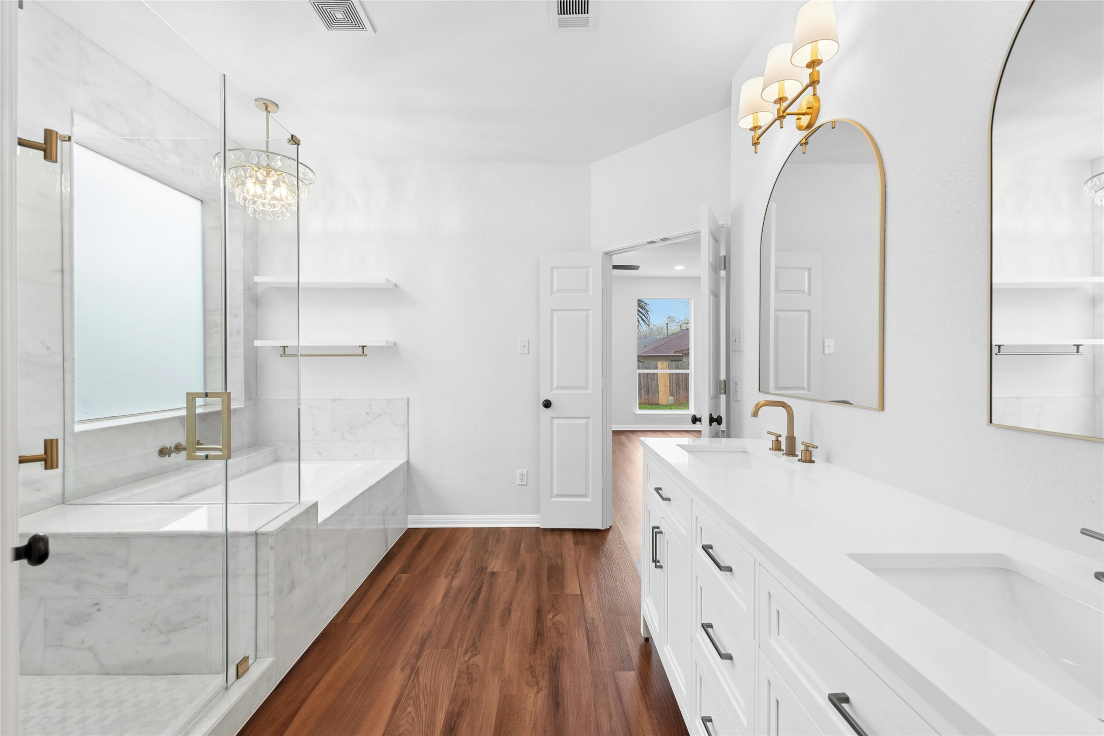 813 Caribou Ridge Trail Pflugerville, TX 78660 - Photo 25 of 39 Spa-inspired primary bathroom featuring a soaking tub, frameless glass walk-in shower with rain shower head, dual vanity, and elegant marble finishes.