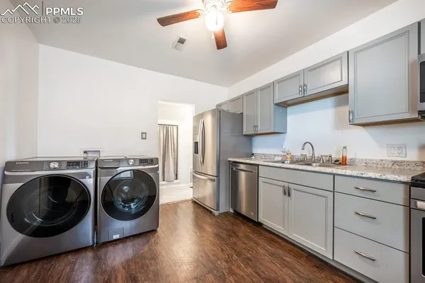 a kitchen with stainless steel appliances sink and cabinets