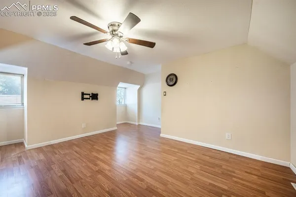 a view of an empty room with wooden floor