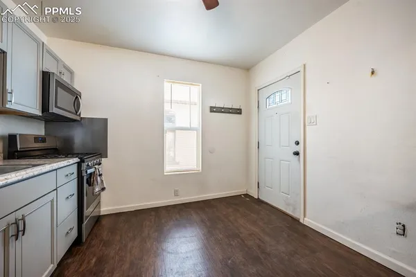a view of a kitchen with dishwasher and wooden floor