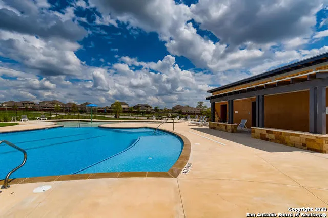 a view of a swimming pool and an outdoor seating