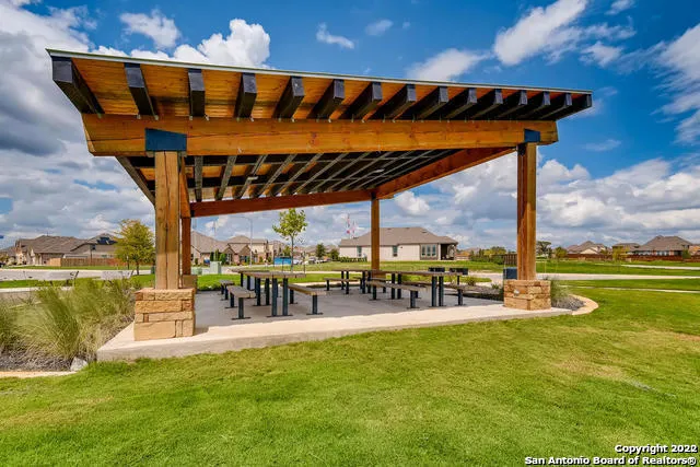 a view of a swimming pool with a patio and a garden