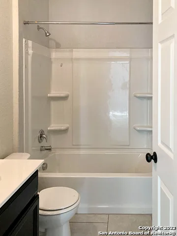 a bathroom with a shower a toilet and a sink