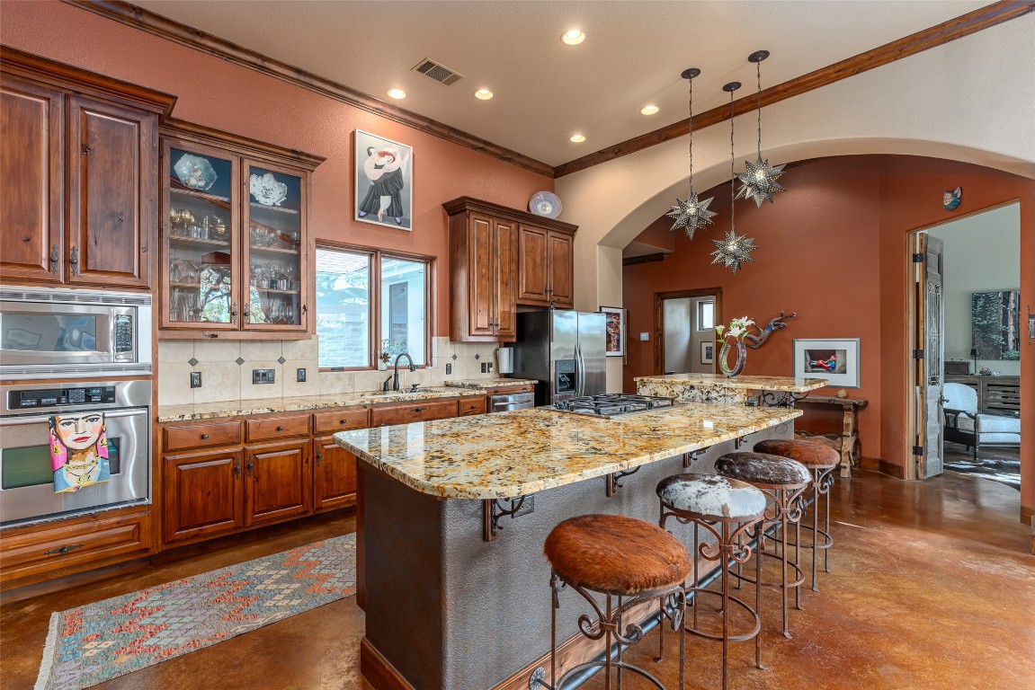 1300 Bluff Street Austin, TX 78704 - Photo 11 of 36 a kitchen with stainless steel appliances granite countertop table chairs sink and cabinets