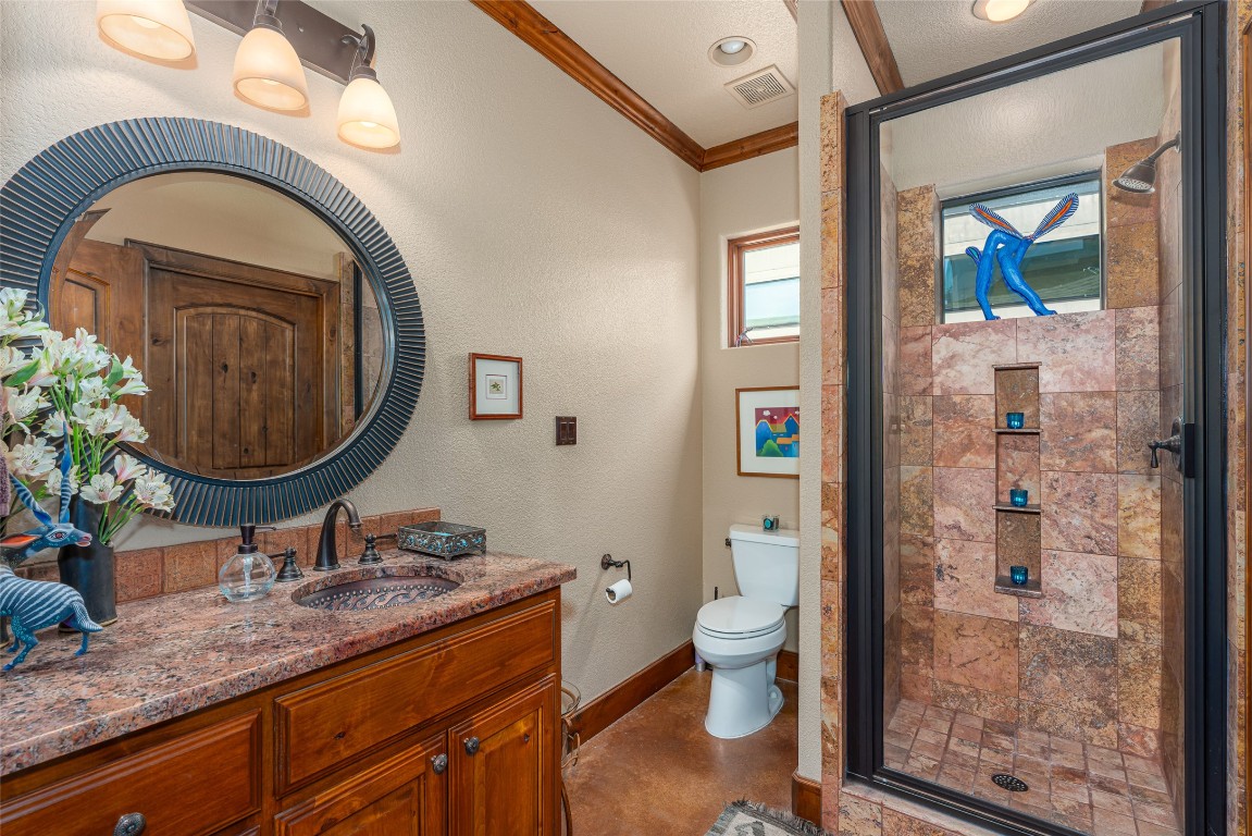 1300 Bluff Street Austin, TX 78704 - Photo 16 of 36 a bathroom with a granite countertop toilet a sink and a mirror