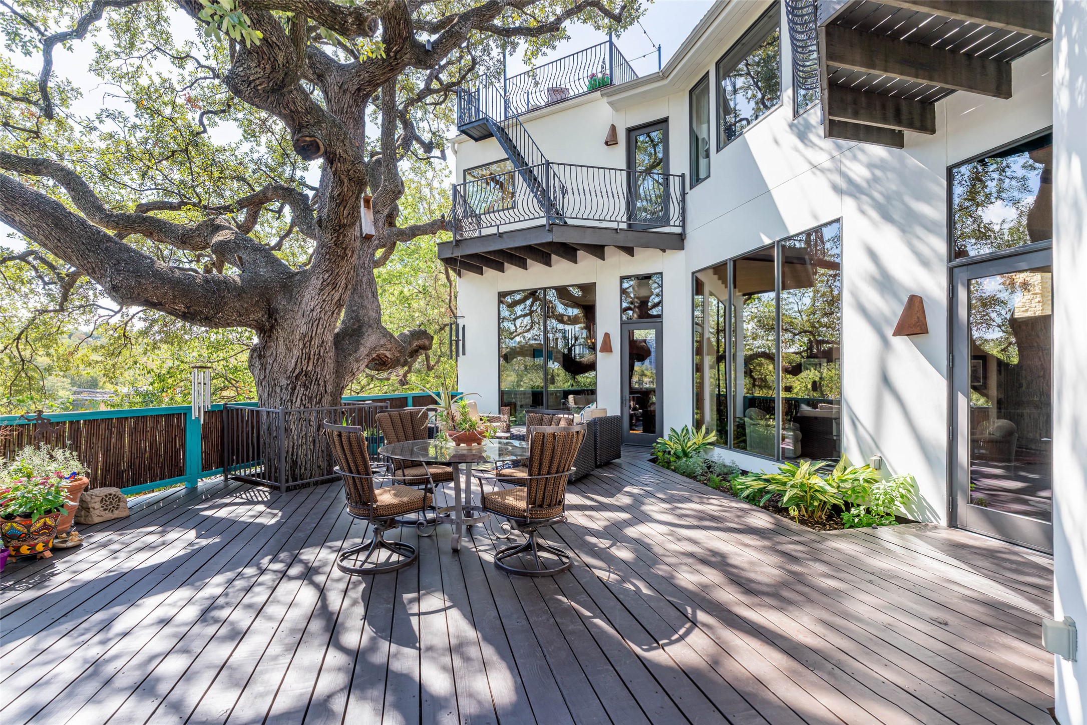 1300 Bluff Street Austin, TX 78704 - Photo 32 of 40 Large back deck/patio area. Second floor shows the primary balcony and rooftop deck.