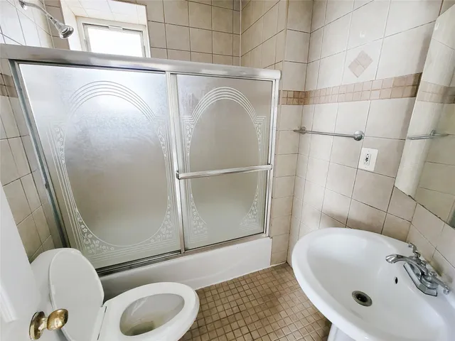 a bathroom with a sink mirror vanity and toilet