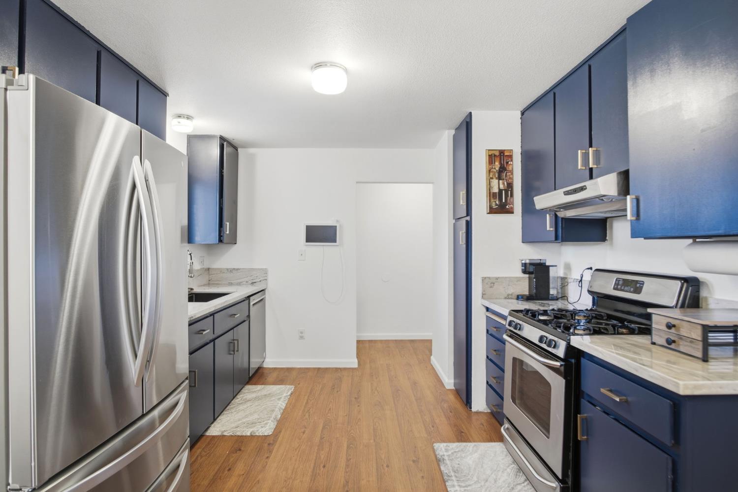 1308 Basil Court Newman, CA 95360 - Photo 7 of 20 a kitchen with stainless steel appliances granite countertop a refrigerator stove and sink