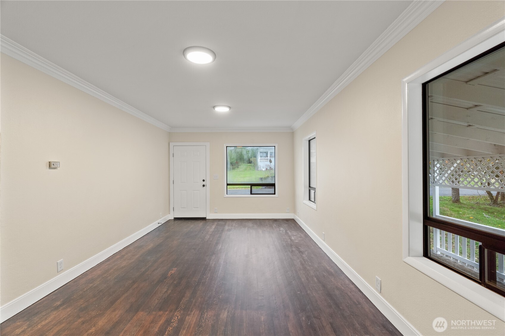 330 Wheeler Avenue Hoquiam, WA 98550 - Photo 6 of 34 a view of an empty room with wooden floor and a window