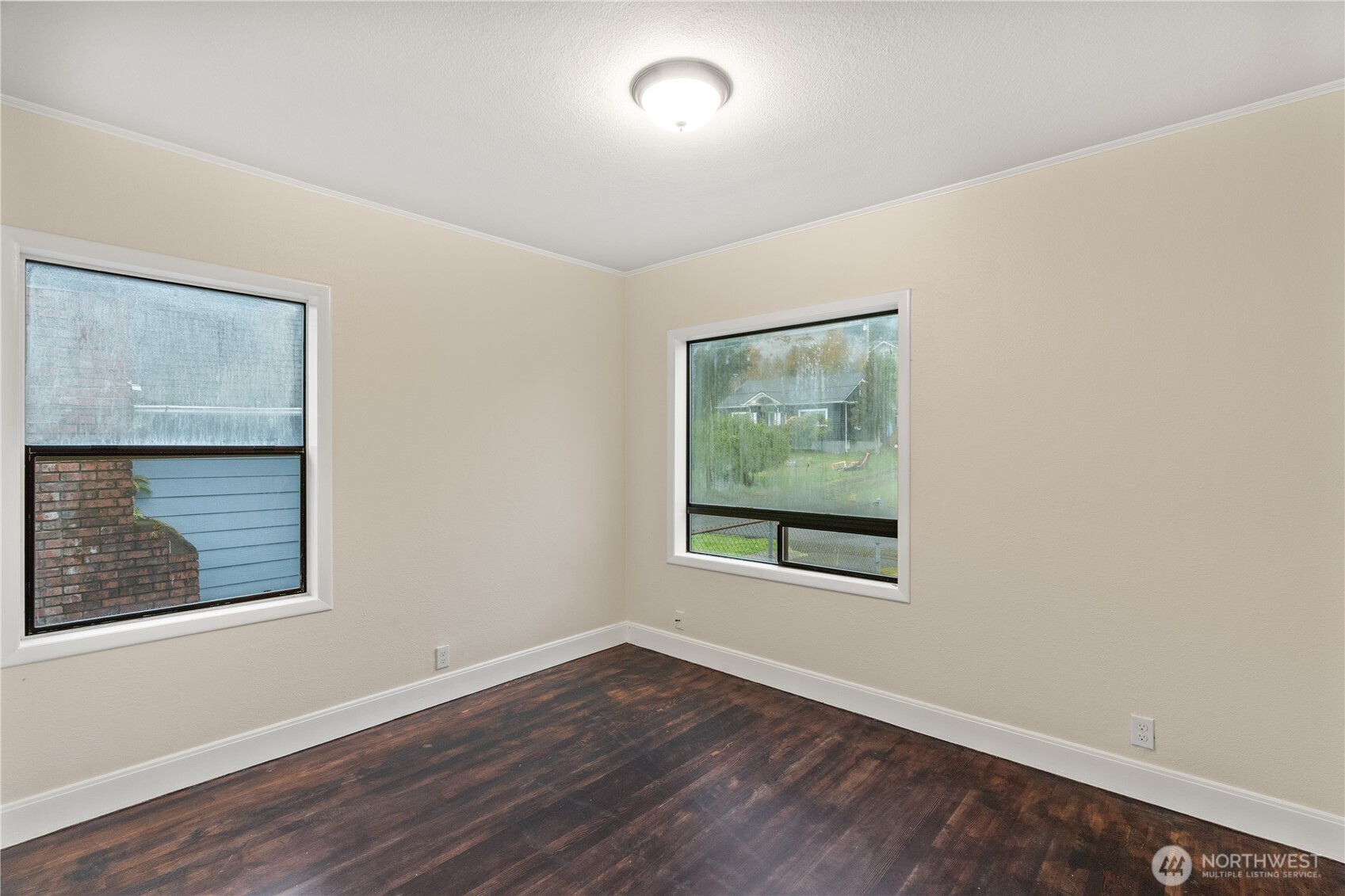330 Wheeler Avenue Hoquiam, WA 98550 - Photo 7 of 34 an empty room with wooden floor and windows