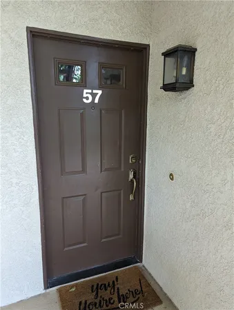 a view of a hallway with wooden floor and cabinet