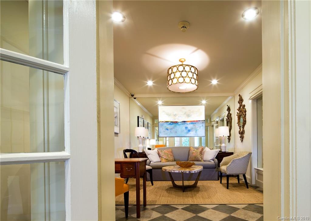 1301 Queens Road, Unit 203 Charlotte, NC 28207 - Photo 3 of 12 a view of a livingroom with furniture and chandelier