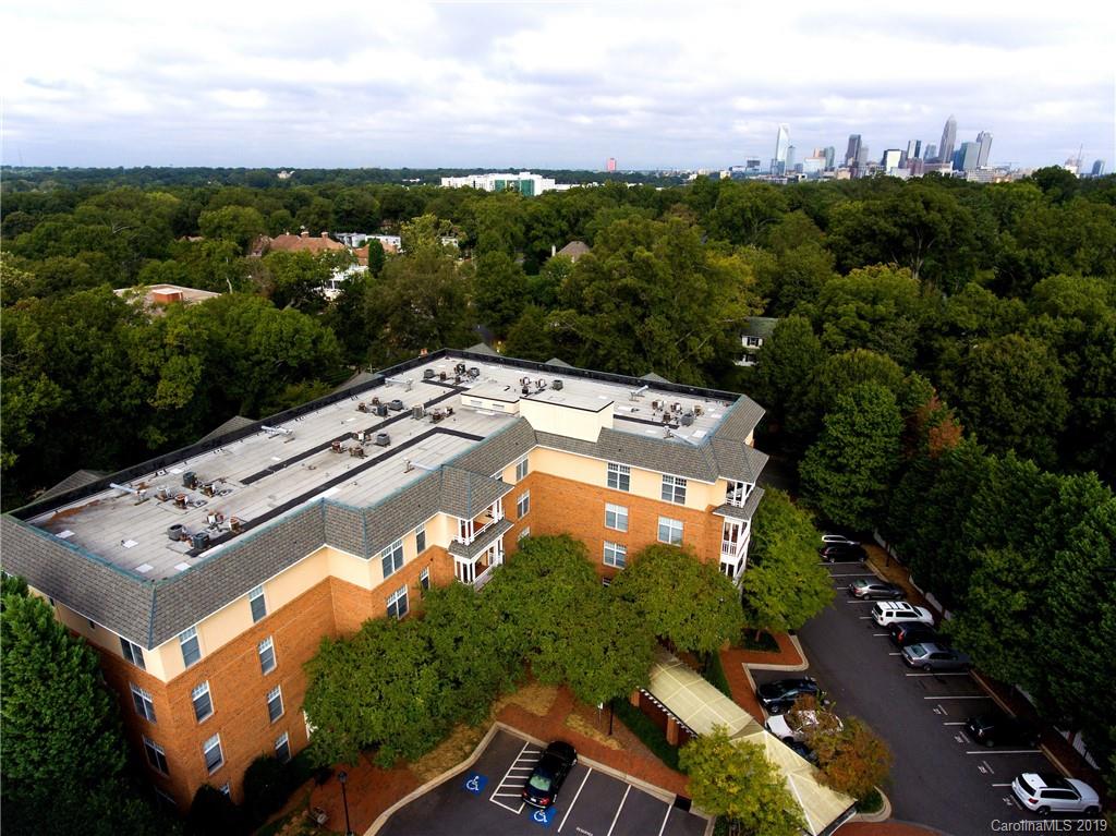 1301 Queens Road, Unit 203 Charlotte, NC 28207 - Photo 10 of 12 an aerial view of a house with a yard swimming pool outdoor seating yard and mountain view in back