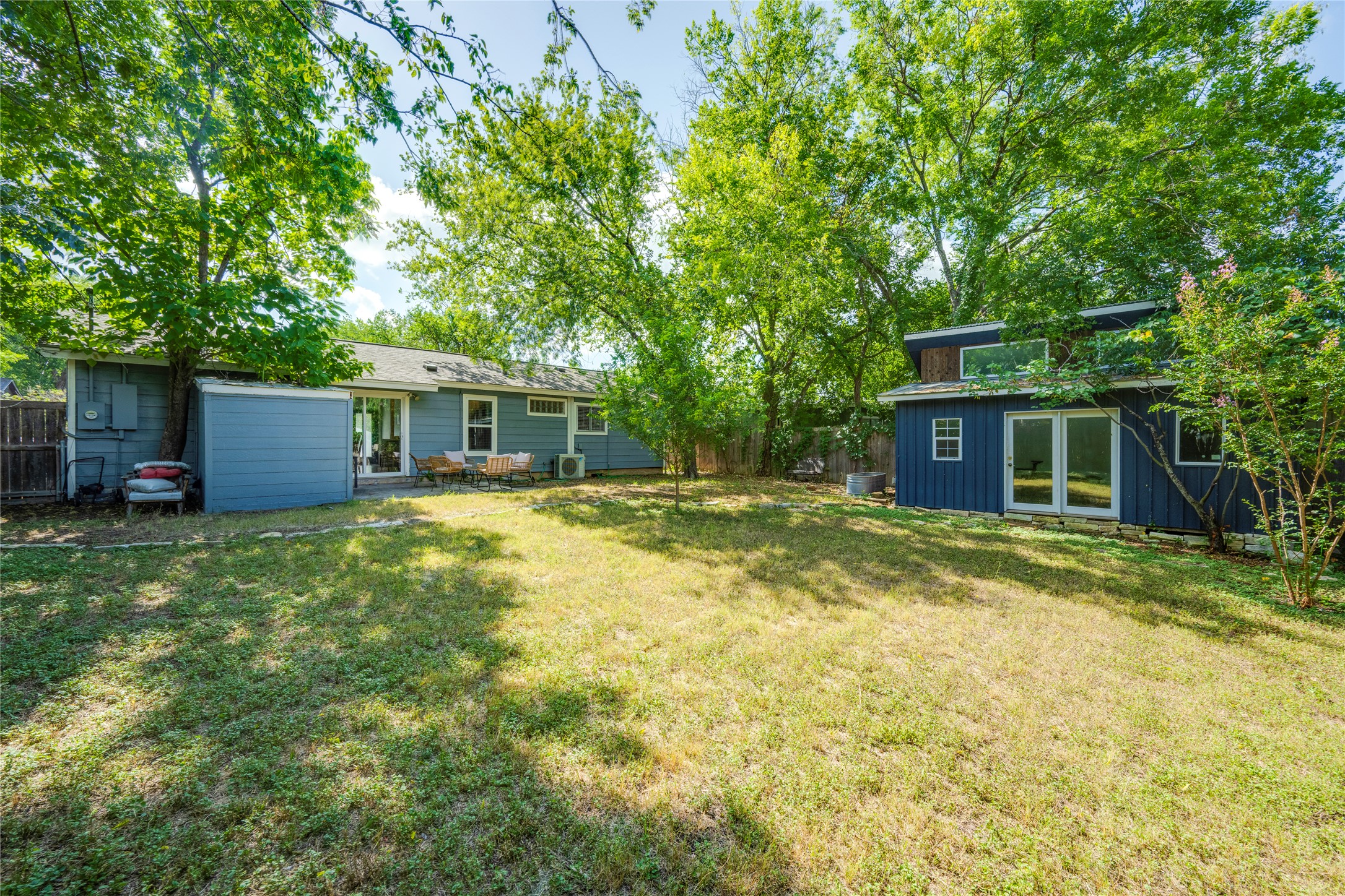 5300 Halmark Drive Austin, TX 78723 - Photo 30 of 40 A spacious yard provides ample green space, surrounded by mature trees for privacy and shade.