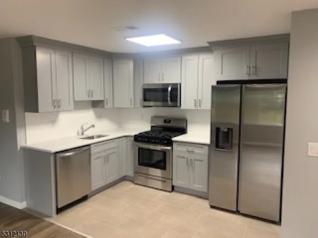 a kitchen with a refrigerator stove and microwave