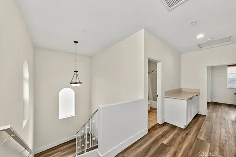 a view of a kitchen with furniture and wooden floor