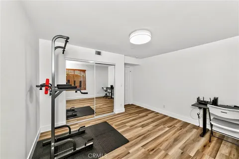 a room with gym equipment and a wooden floor