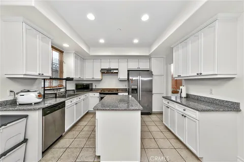 a kitchen with refrigerator and cabinets