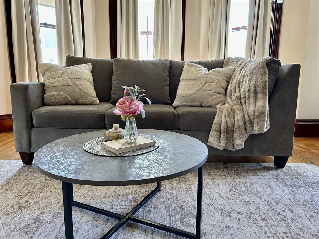 a living room with furniture and a large mirror