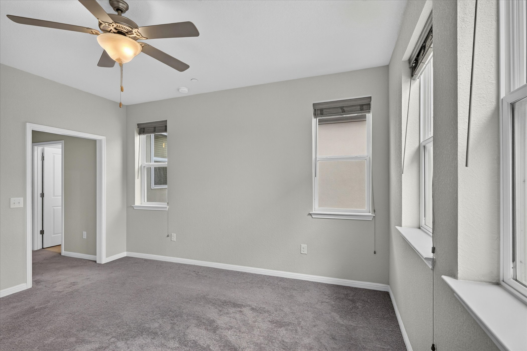 9015 Cattle Baron Path, Unit 1102 Austin, TX 78747 - Photo 11 of 25 Well-lit living area features neutral tones and a ceiling fan for year-round comfort.