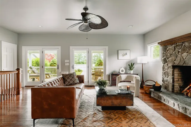 a living room with furniture fireplace and a large window